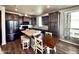 Well-equipped kitchen with dark cabinets, a marble island, and a dining table at 8865 E Baseline Rd # 614, Mesa, AZ 85209