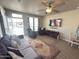 Comfortable living room with tile floors, ceiling fan, and large windows providing natural light at 8865 E Baseline Rd # 614, Mesa, AZ 85209