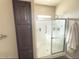 Modern shower with glass doors and a built-in seat, complemented by a storage cabinet at 8865 E Baseline Rd # 614, Mesa, AZ 85209