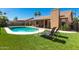 Backyard featuring a pool, artificial grass, covered patio with furniture, and a BBQ grill at 901 N Quartz St, Gilbert, AZ 85234