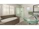 Bathroom with glass bowl sinks, a separate shower, and a soaking tub at 901 N Quartz St, Gilbert, AZ 85234
