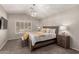 Bright bedroom with a decorative light fixture and a large window with wooden shutters at 901 N Quartz St, Gilbert, AZ 85234