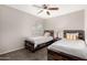 Bedroom featuring two twin beds with wood frames and matching nightstand, plus a ceiling fan at 901 N Quartz St, Gilbert, AZ 85234