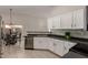 Bright kitchen with stainless steel appliances, white cabinetry, and bar seating at 901 N Quartz St, Gilbert, AZ 85234