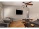 Spacious living room with a ceiling fan, hardwood floors and comfortable chairs at 901 N Quartz St, Gilbert, AZ 85234