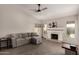 Comfortable living room featuring a fireplace, ceiling fan, and cozy sectional couch at 901 N Quartz St, Gilbert, AZ 85234