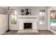 Living room with fireplace, offering a view of the pool outside, and natural light at 901 N Quartz St, Gilbert, AZ 85234