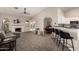 Open living area with a fireplace, bar seating, and view of the backyard pool at 901 N Quartz St, Gilbert, AZ 85234