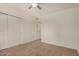 Cozy bedroom with neutral carpet, a ceiling fan, and a closet for ample storage space at 908 S Kachina --, Mesa, AZ 85204