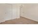 This bedroom offers carpeted floors, closet doors, and entry to another area of the home at 908 S Kachina --, Mesa, AZ 85204
