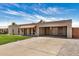 Charming single-story brick home with a covered parking area and a well-maintained driveway at 908 S Kachina --, Mesa, AZ 85204