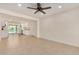 Bright, open-concept living room with neutral tile and an adjacent kitchen area, freshly painted at 908 S Kachina --, Mesa, AZ 85204