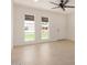 Bright living room with neutral tile flooring, large windows, and modern ceiling fan at 908 S Kachina --, Mesa, AZ 85204
