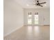 Bright, modern living room featuring neutral tile flooring, two windows, and a ceiling fan at 908 S Kachina --, Mesa, AZ 85204