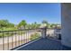 Exterior balcony with black metal railing overlooking street and community landscaping at 9705 E Mountain View Rd # 1096, Scottsdale, AZ 85258