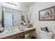 Bright bathroom featuring a vanity with neutral countertop and traditional wood cabinetry at 9705 E Mountain View Rd # 1096, Scottsdale, AZ 85258