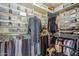 A walk-in closet with shelves and hanging racks, perfect for organizing clothes and accessories at 9705 E Mountain View Rd # 1096, Scottsdale, AZ 85258