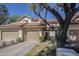 Charming home featuring a stucco facade, tiled roof, and two-car garage, with a mature tree in the front yard at 9705 E Mountain View Rd # 1096, Scottsdale, AZ 85258