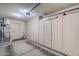 Garage interior featuring built-in storage cabinets and ample parking space at 9705 E Mountain View Rd # 1096, Scottsdale, AZ 85258