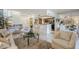 Bright living room with a view of the kitchen and staircase, offering an open layout perfect for modern living at 9705 E Mountain View Rd # 1096, Scottsdale, AZ 85258