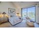 Serene main bedroom with a plush bed, sitting area, and balcony access, offering a relaxing retreat at 9705 E Mountain View Rd # 1096, Scottsdale, AZ 85258