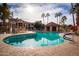 A stunning pool area surrounded by palm trees and comfortable seating, ideal for relaxation and recreation at 9705 E Mountain View Rd # 1096, Scottsdale, AZ 85258