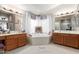 This bright bathroom has a soaking tub with large windows and double sinks at 991 N Quail Ln, Gilbert, AZ 85233