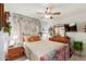 Cozy bedroom featuring a ceiling fan, vintage dresser, and soft lighting at 991 N Quail Ln, Gilbert, AZ 85233