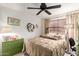Charming bedroom with a decorative heart wreath and modern ceiling fan at 991 N Quail Ln, Gilbert, AZ 85233