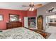 This primary bedroom features a ceiling fan, dresser, and ensuite bathroom at 991 N Quail Ln, Gilbert, AZ 85233