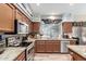 Well-appointed kitchen with stainless steel appliances, granite countertops, and ample storage space at 991 N Quail Ln, Gilbert, AZ 85233