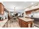 Open concept kitchen with stainless steel appliances and center island, flowing into the living spaces at 991 N Quail Ln, Gilbert, AZ 85233