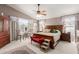 Spacious main bedroom featuring plush carpet, large windows, and a ceiling fan at 991 N Quail Ln, Gilbert, AZ 85233