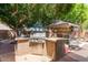 Built-in stainless steel outdoor grill with counter space, under a shaded canopy at 991 N Quail Ln, Gilbert, AZ 85233