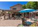 Spacious patio with outdoor furniture, decor, and a blue umbrella, perfect for relaxation at 991 N Quail Ln, Gilbert, AZ 85233