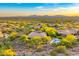 Expansive aerial view of a desert landscape featuring a community pool and mountain range backdrop at 10694 E Redfield Rd, Scottsdale, AZ 85255