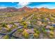 Panoramic aerial view showcasing a desert community nestled in a landscape with winding roads and mountain views at 10694 E Redfield Rd, Scottsdale, AZ 85255