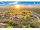 Aerial view of a desert home, showcasing the surrounding landscape and serene setting with mountain views at 10694 E Redfield Rd, Scottsdale, AZ 85255