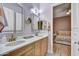 Double vanity bathroom leading to a cozy bedroom with wood floors at 10694 E Redfield Rd, Scottsdale, AZ 85255
