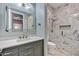 Modern bathroom featuring marble walk-in shower, sleek vanity, and illuminated mirror at 10694 E Redfield Rd, Scottsdale, AZ 85255