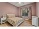 Cozy bedroom features a ceiling fan, floral bedding, and a bright window view at 10694 E Redfield Rd, Scottsdale, AZ 85255