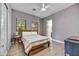 Cozy bedroom with natural light, queen bed, hardwood floors, and minimalist decor at 10694 E Redfield Rd, Scottsdale, AZ 85255