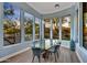 Elegant dining area with floor-to-ceiling windows, a modern light fixture, and beautiful desert landscape views at 10694 E Redfield Rd, Scottsdale, AZ 85255