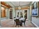 Formal dining room featuring modern décor, unique wall art, and elegant lighting with a view through french doors at 10694 E Redfield Rd, Scottsdale, AZ 85255