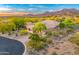 Exterior view of a charming single-story desert home with mature trees and meticulously manicured landscaping at 10694 E Redfield Rd, Scottsdale, AZ 85255