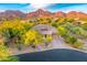 Beautiful single-Gathering home with desert landscaping and a majestic mountain backdrop at sunset at 10694 E Redfield Rd, Scottsdale, AZ 85255
