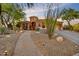 Charming single-story home with desert landscaping and a paved walkway to the front door at 10694 E Redfield Rd, Scottsdale, AZ 85255