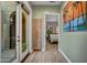 Hallway leading to a bedroom, features a built in storage cabinet and view to a courtyard at 10694 E Redfield Rd, Scottsdale, AZ 85255