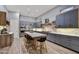 Stylish kitchen with blue cabinets, stainless steel appliances, marble countertops, and a large center island at 10694 E Redfield Rd, Scottsdale, AZ 85255