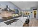 Modern kitchen showcasing stainless steel appliances, marble countertops, and desert views from large windows at 10694 E Redfield Rd, Scottsdale, AZ 85255